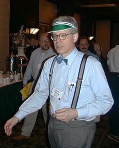 Stalwart copy editor John McIntyre of The Baltimore Sun models a green eyeshade at the 2000 ACES conference. Not many of us wear them anymore, or bow ties and suspenders either. Image from poynter.org.