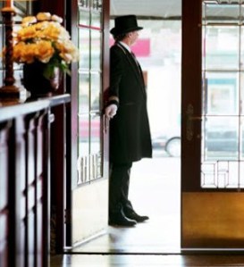 Opening a door for someone is a welcome gesture. Uniform not necessary, though. Image from suburbkid.com.