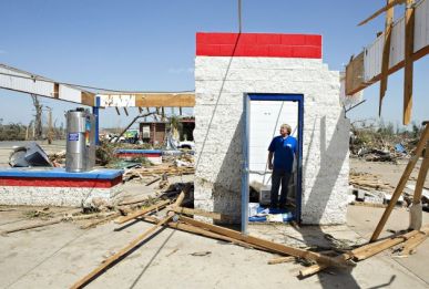 Ken Sullivan, general manager of We Willies Super Auto Wash, looks over the damage after a tornado tore through the area for the second time in three years in Vilonia. Photo: Wesley Hitt, Getty Images 