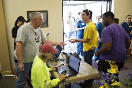 Ken Brown hands out IDs Monday at Beryl Baptist Church to volunteers after a tornado Sunday tore through the Vilonia area for the second time in three years. Wesley Hitt, Getty Images.