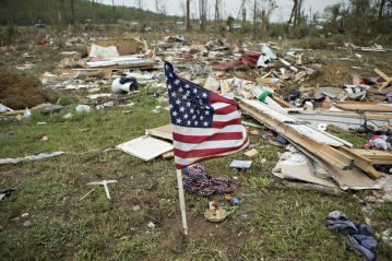 A flag flies amid the debris after the Vilonia tornado. Image by Wesley Hitt, Getty Images.