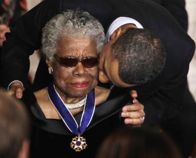 President Barack Obama kisses author and poet Maya Angelou after awarding her the 2010 Medal of Freedom during a ceremony in the East Room of the White House in Washington on Feb. 15, 2011. Image by Charles Dharapak, AP.