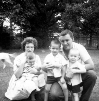 This was a few years before I came along. Mom's holding Corey, Mitch is in the middle, and Kevin's in front of Daddy.