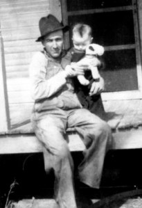 Grandpa Carl, who died three years before I was born, holding my dad.