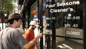Jeff Deck holds the door for Benjamin Herson as they enter a dry cleaning establishment in Philadelphia to ask if they can remove the errant apostrophe in the name. Image by MCT,