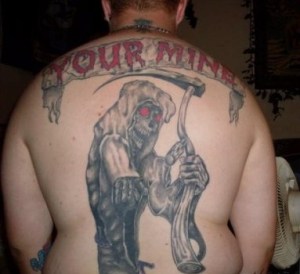 As if the ugly tattoo wasn't bad enough, it should be "you're," not "your." Image from Grammar Monster,