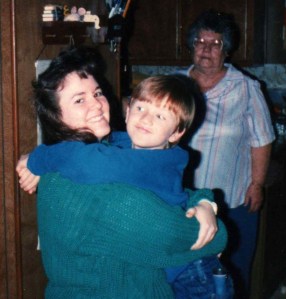 David gives his Aunt Brenda a hug while his great-grandma looks on.