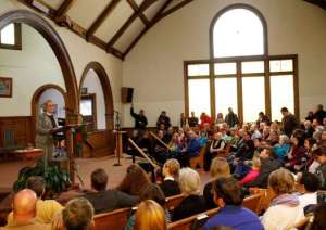 The Rev. Nori Rost leads a vigil for the Planned Parenthood shooting victims at All Souls Unitarian Universalist Church. Image By David Zabulowski, Associated Press.