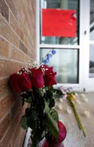 Roses stand outside the door of the Planned Parenthood clinic in Colorado Springs. Image by David Zalubowski, Associated Press.